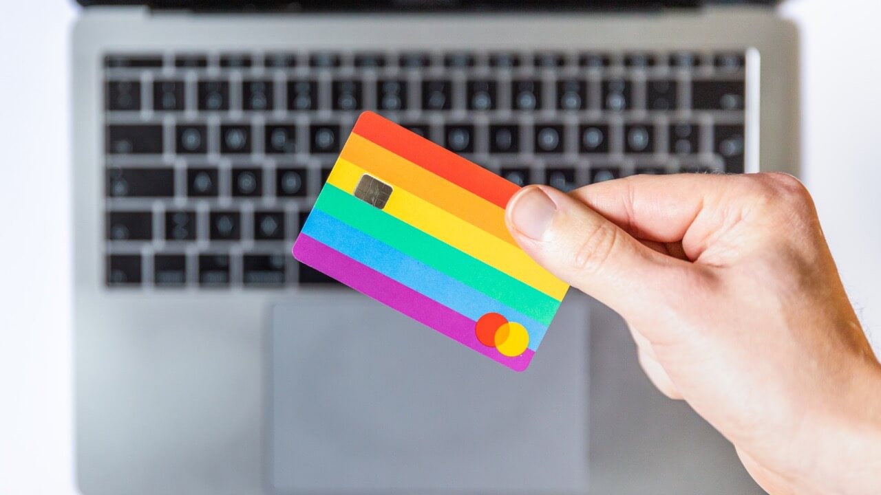 Rainbow credit card with macbook on a background